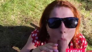 Redhead with large breasts performs an outdoor blowjob