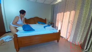 Nudist housekeeper Regina Noir makes the bedding in the bedroom. Naked maid. Naked housewife. 1